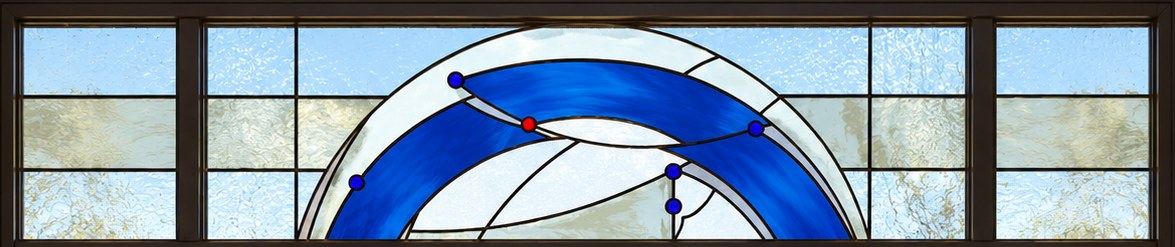 The stained glass transom with a sweeping cobalt blue arc and glass jewels, private home in Bar, Montenegro