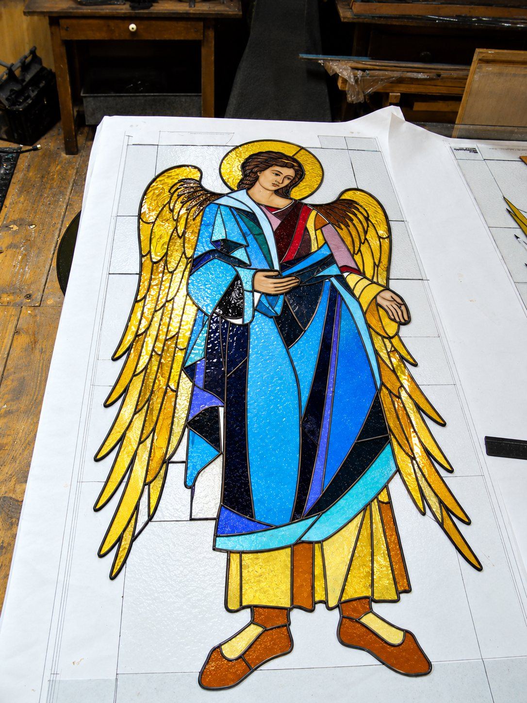 An angel in stained glass laid out on the full size drawing in the studio, Sombor