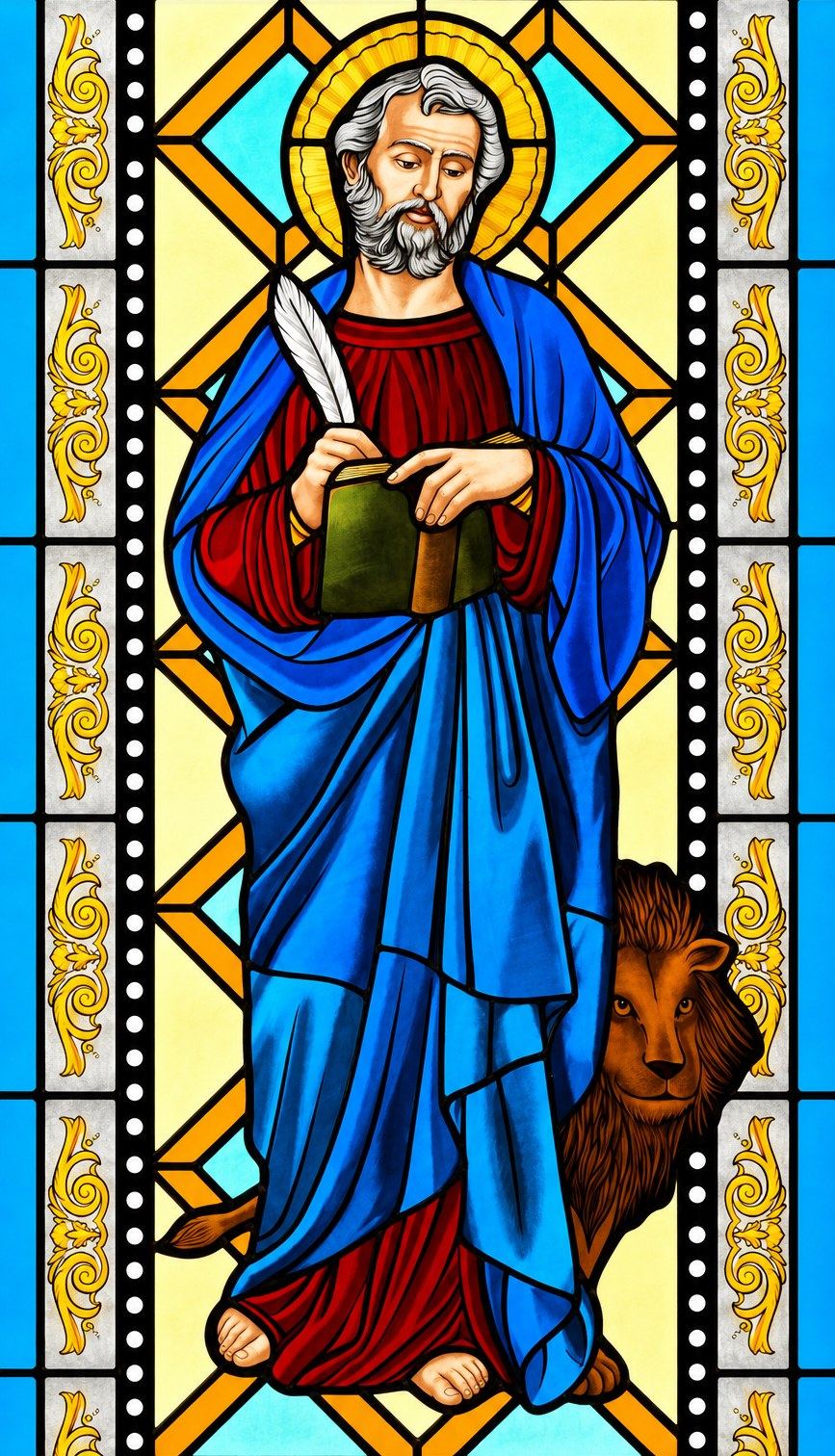 Stained glass window of Saint Mark the Evangelist with his book and lion in Hrasno