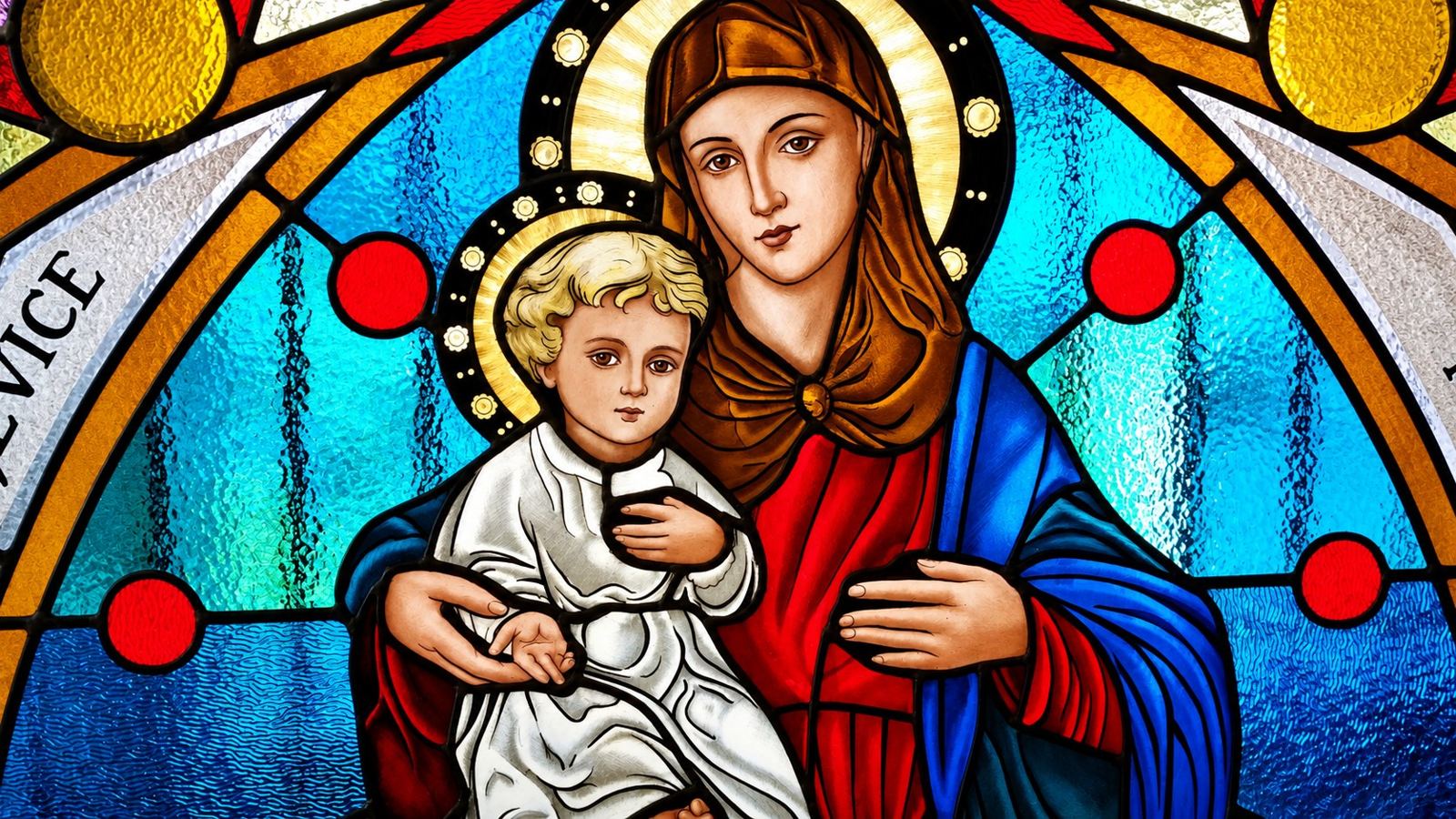 Detail of the stained glass lunette in Hrasno: Mary holding the Child, painted and fired by hand