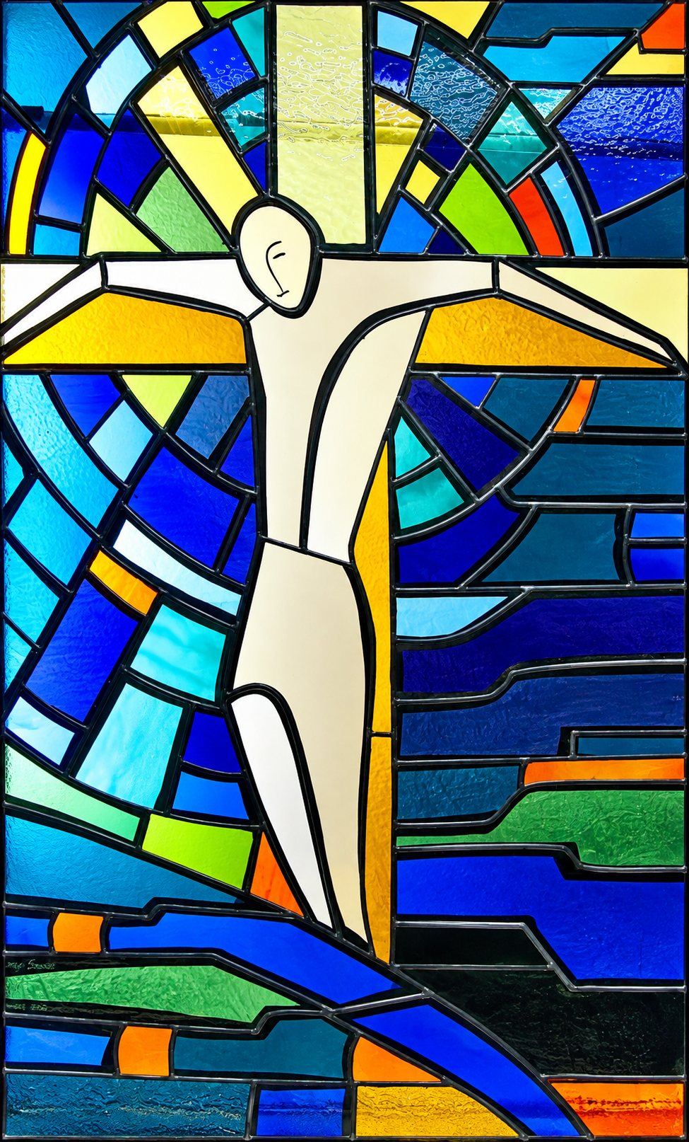 Modern stained glass window of Christ on the cross with rays of light and waves of blue, City Chapel in Petrovac