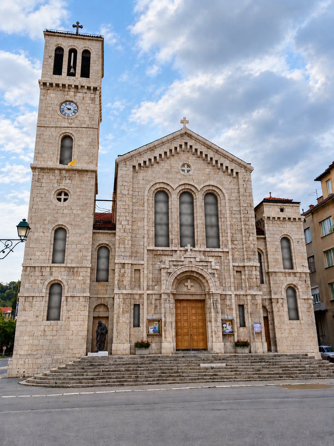 The pale stone facade and bell tower of the Church of Saint Joseph in Marijin Dvor, Sarajevo