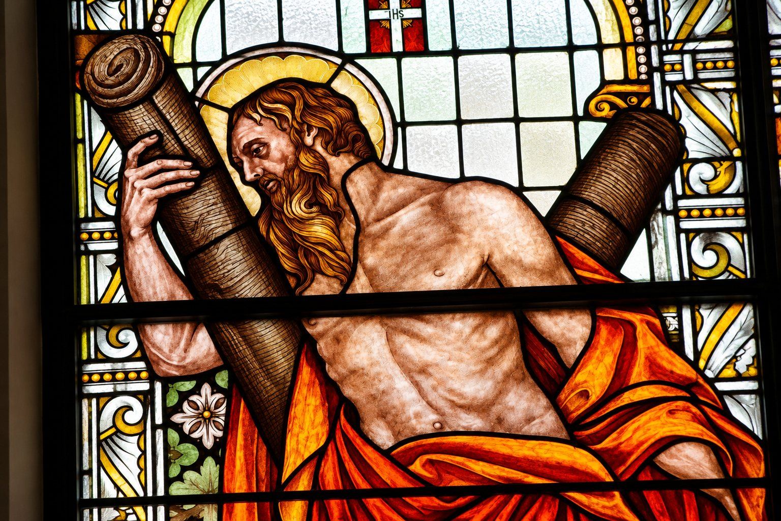 Restored stained glass detail of Saint Andrew carrying his X shaped cross, Saint Joseph, Sarajevo