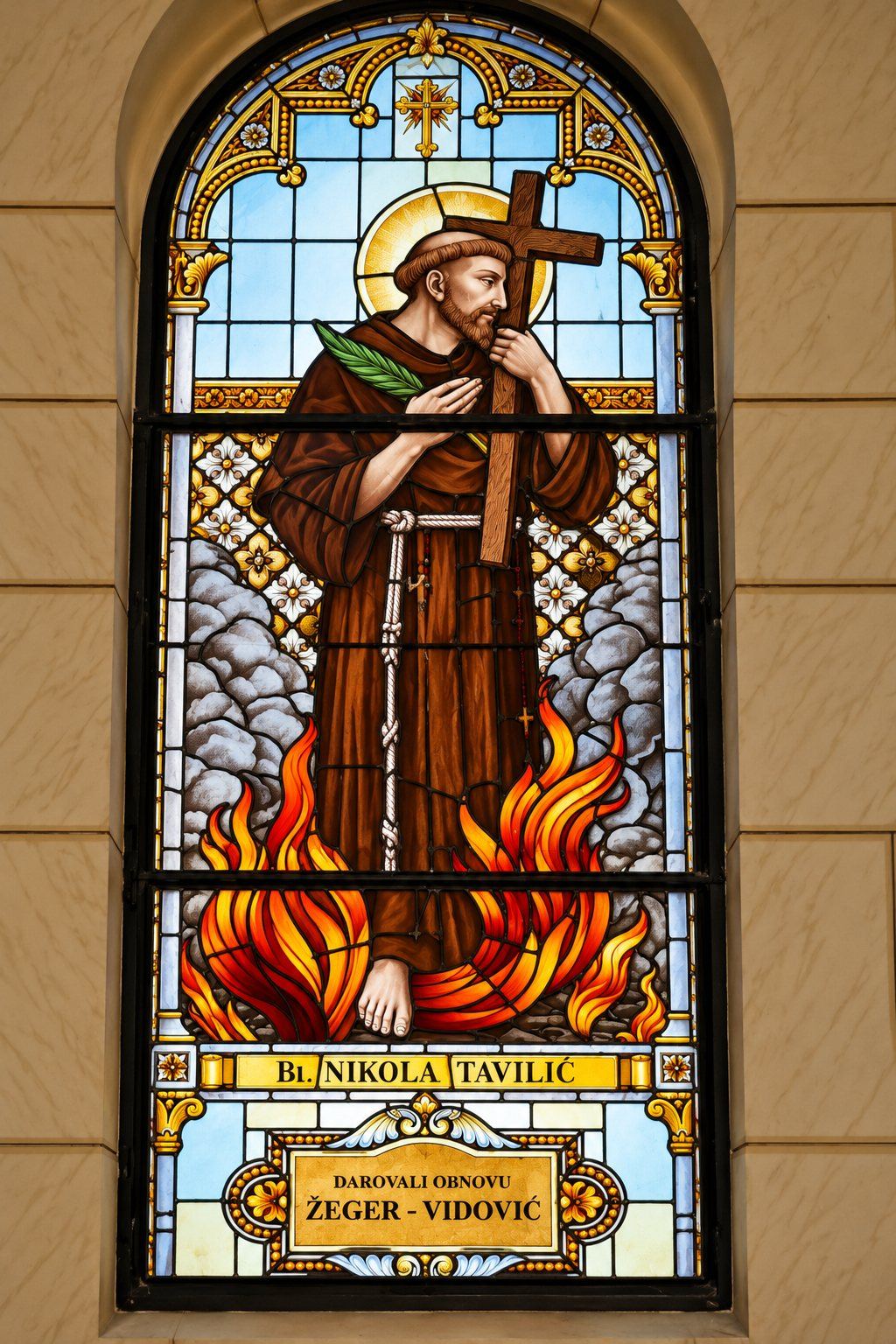 Restored stained glass window of Nikola Tavelić in the flames with a cross and palm, Saint Joseph, Sarajevo