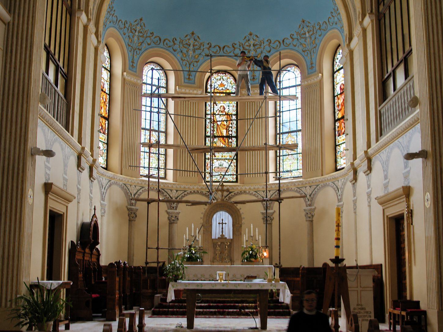 Scaffolding in the apse of the Church of Saint Joseph in Sarajevo during the stained glass restoration, a worker at the top