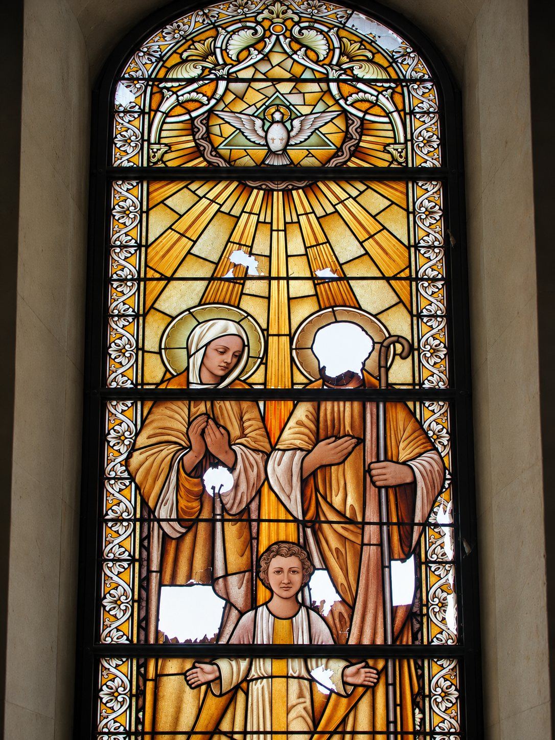 War damaged stained glass window of the Holy Family with the faces missing, Saint Joseph, Sarajevo
