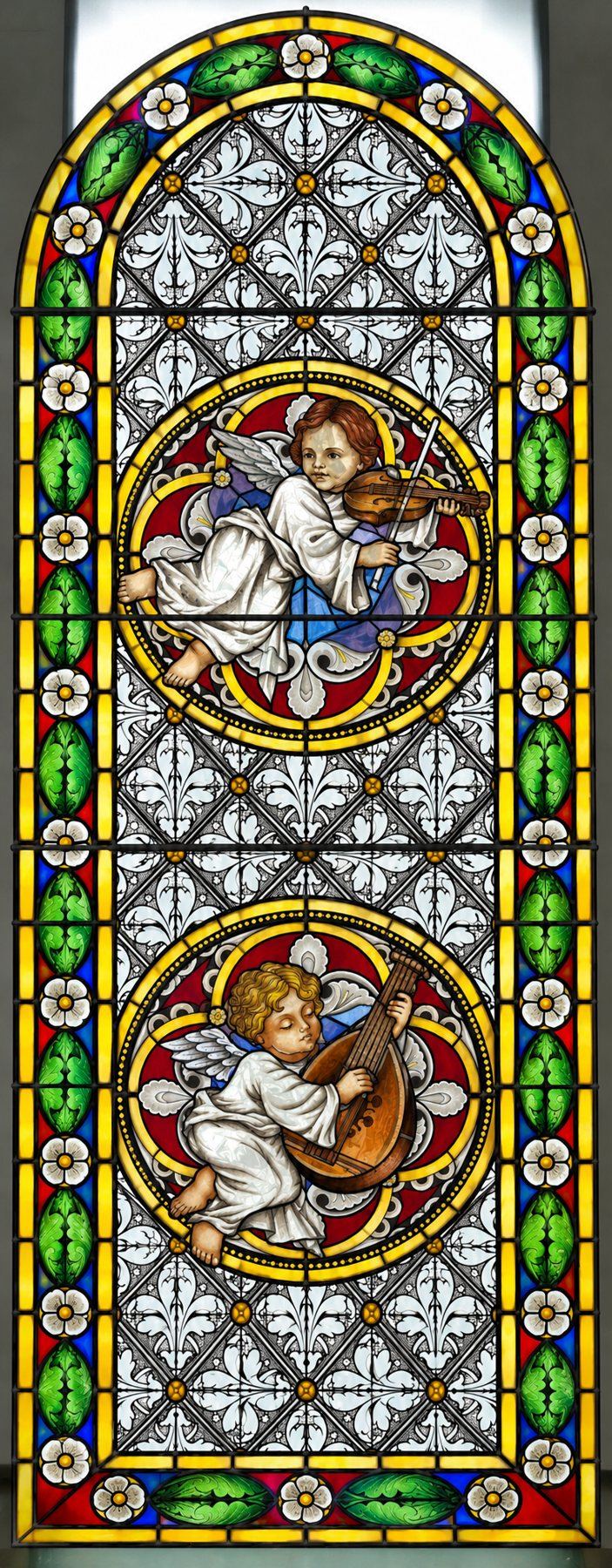 Stained glass window of angels playing the violin and the lute, Stolac