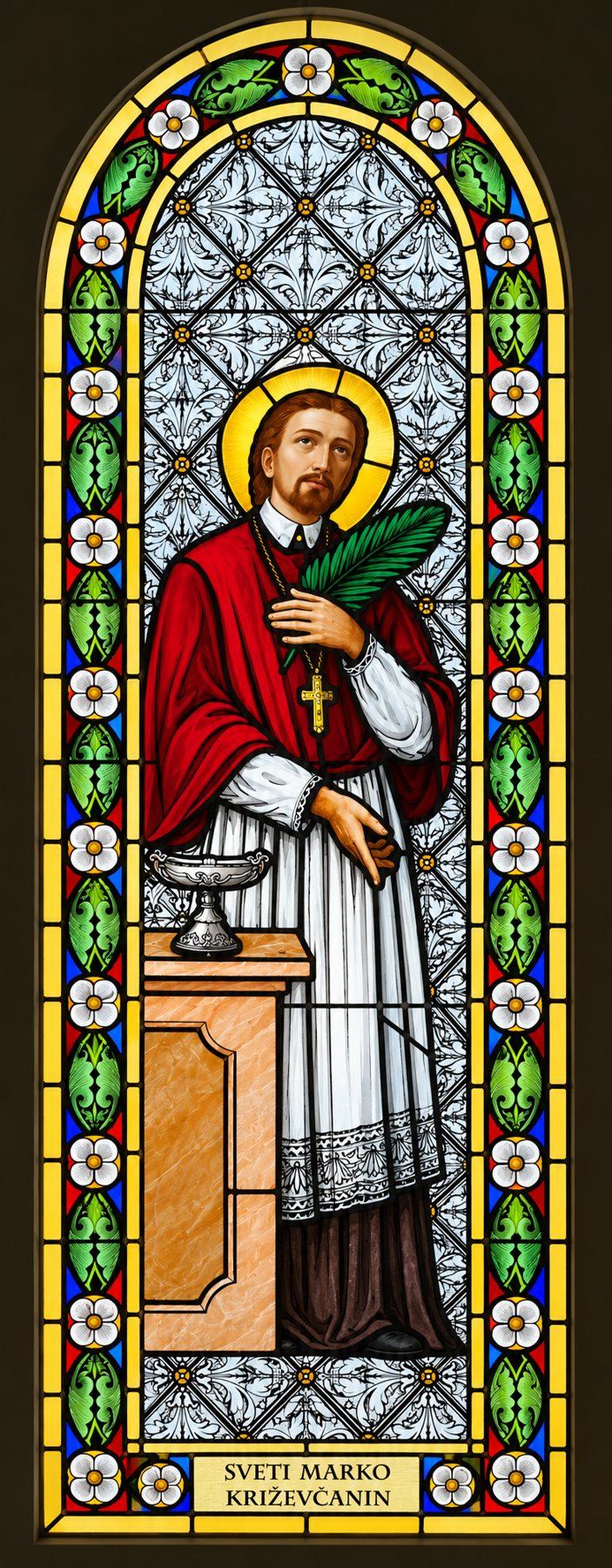 Stained glass window of Saint Marko Križevčanin in a red cape with a palm branch, Stolac