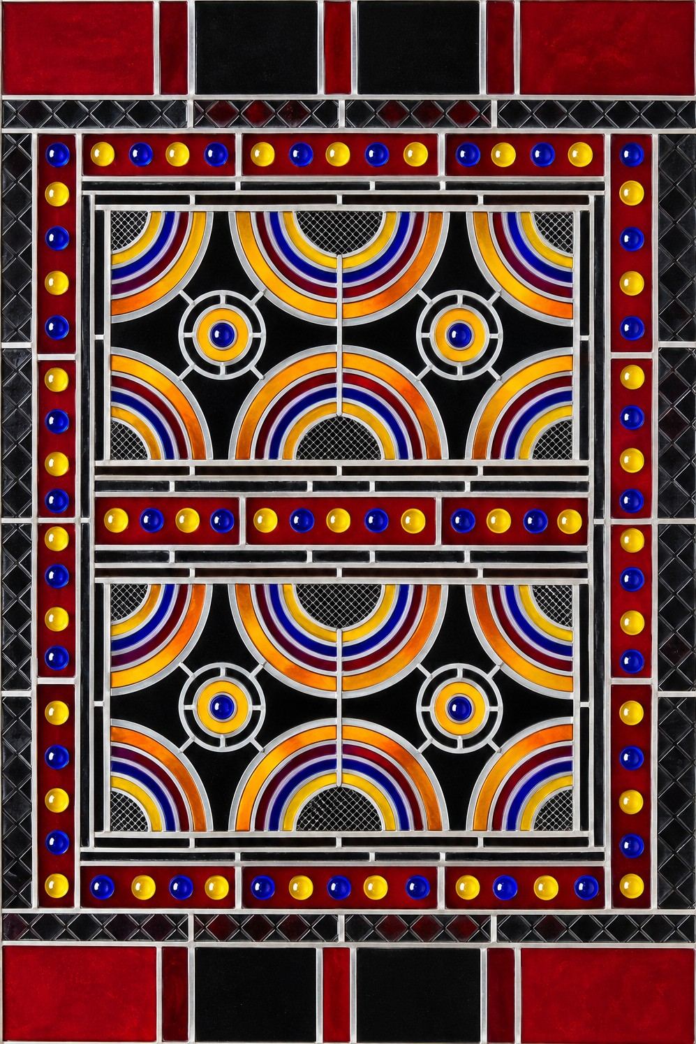 The restored stained glass panel from the U.S. Embassy in Riyadh, with jeweled red borders and concentric amber, red and blue arcs on black