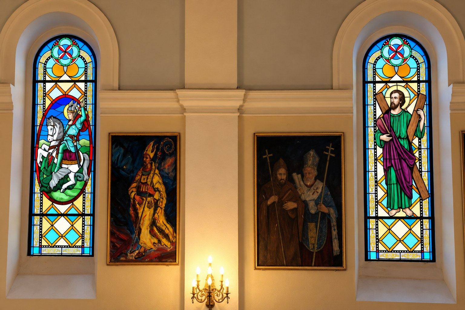 The nave of the church in Hrasno with the stained glass windows of Saint George and Saint Andrew between paintings of saints