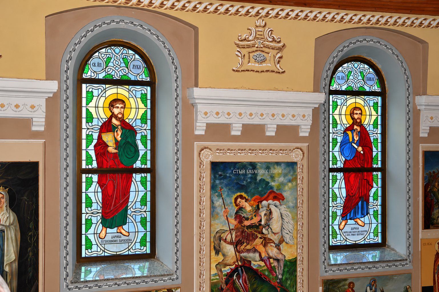 The painted walls, icons and stained glass windows inside the Greek Catholic church in Mikluševci