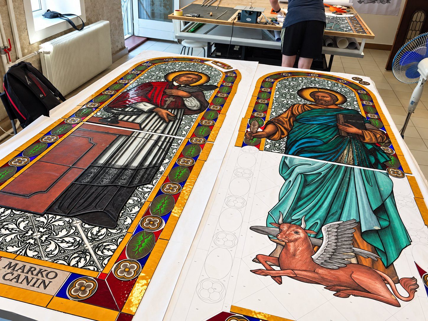 Painted stained glass panels of Saint Marko Križevčanin and Saint Luke the Evangelist on the light tables of Stanisic Studio in Sombor, Serbia, for the church in Stolac