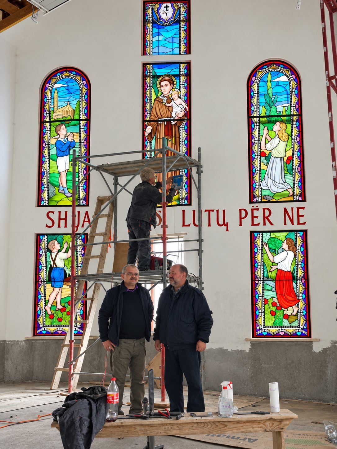 Stevan Stanisic, left, and architect Vlado Caričić, right, below the scaffold during the installation of the stained glass, Pastoral Centre in Tuzi